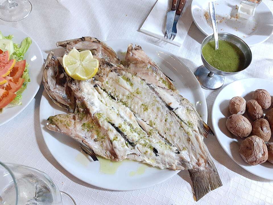 Canarian food: grilled vieja fish with wrinkly potatoes and green mojo